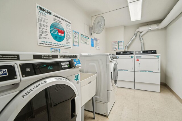 200 Winston Dr Unit 803, Cliffside Park, NJ 07010 - community laundry with washing machine and dryer and light tile patterned floors