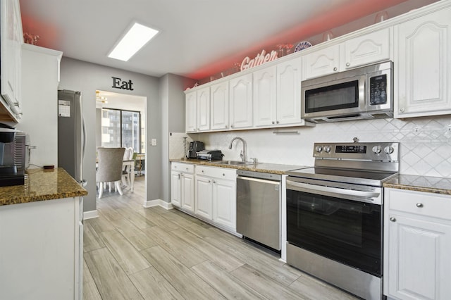 200 Winston Dr Unit 803, Cliffside Park, NJ 07010 - kitchen featuring appliances with stainless steel finishes, white cabinets, and tasteful backsplash