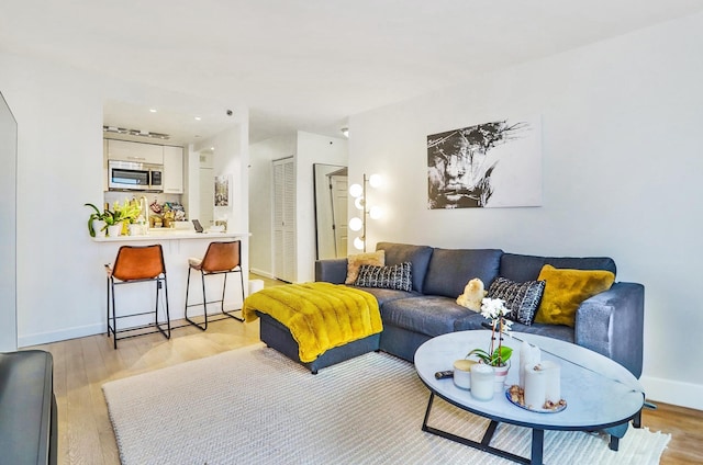 20 2nd St Unit 2001, Jersey City, NJ 07302 - living area featuring light wood-type flooring and baseboards