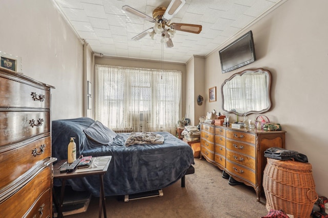 bedroom featuring carpet floors, ceiling fan, and ornamental molding