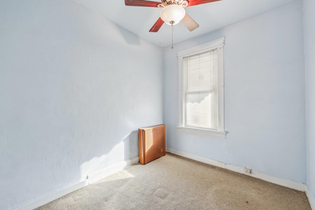 empty room with a ceiling fan, baseboards, and carpet floors