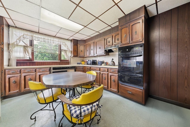 81 Atlantic St, Jersey City, NJ 07304 - kitchen with oven, a warming drawer, light floors, under cabinet range hood, and light countertops