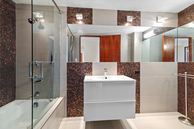 200 Old Palisade Rd Ph 4/5, Fort Lee, NJ 07024 - bathroom featuring tile walls, shower / bath combination with glass door, and vanity