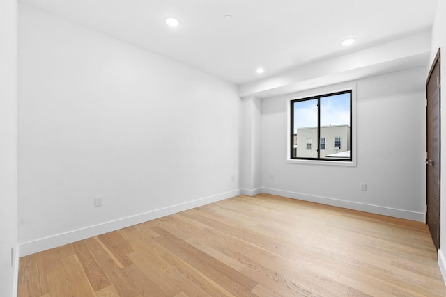 spare room featuring light hardwood / wood-style floors