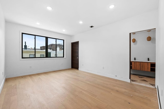 unfurnished room featuring light hardwood / wood-style floors