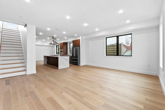 unfurnished living room with light hardwood / wood-style floors