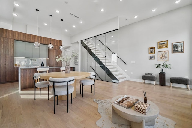 371 New York Ave Unit 2, Jersey City, NJ 07307 - dining space with stairway, light wood-style flooring, recessed lighting, and a high ceiling