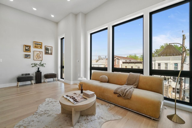 371 New York Ave Unit 2, Jersey City, NJ 07307 - living area featuring plenty of natural light, wood finished floors, recessed lighting, and a towering ceiling