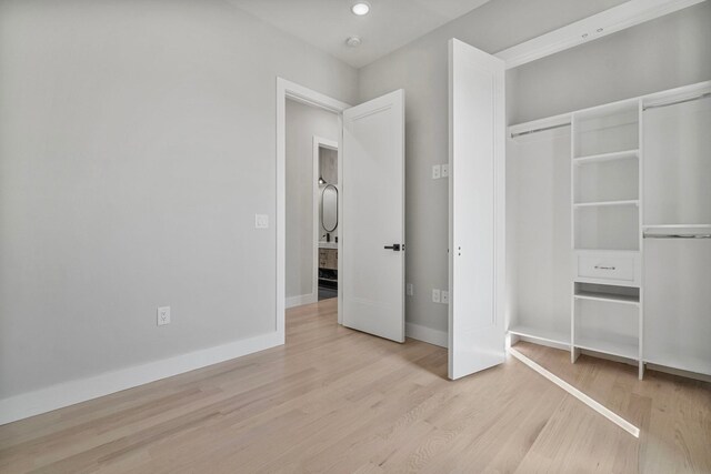 371 New York Ave Unit 2, Jersey City, NJ 07307 - unfurnished bedroom featuring wood finished floors, a closet, and recessed lighting