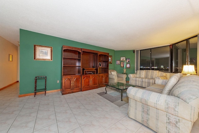 tiled living room featuring a textured ceiling