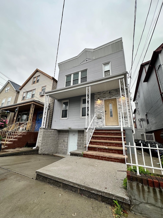 29 W 26th St, Bayonne, NJ 07002 - view of property with covered porch and stone siding