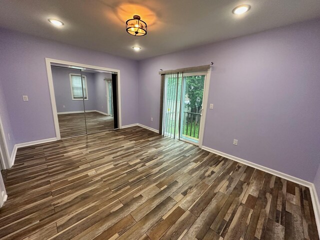 29 W 26th St, Bayonne, NJ 07002 - unfurnished bedroom with multiple windows, dark wood finished floors, baseboards, a closet, and recessed lighting