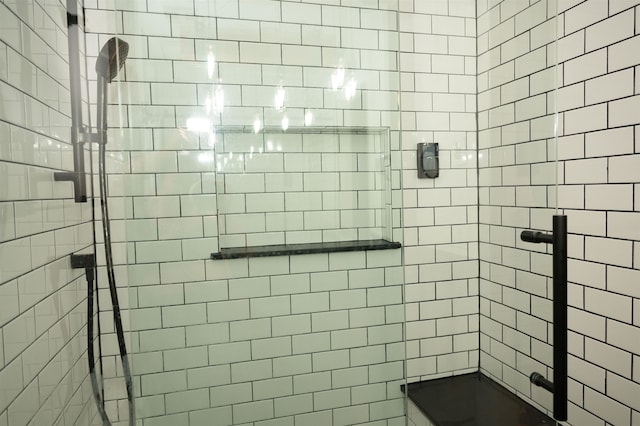 bathroom featuring a shower with shower door