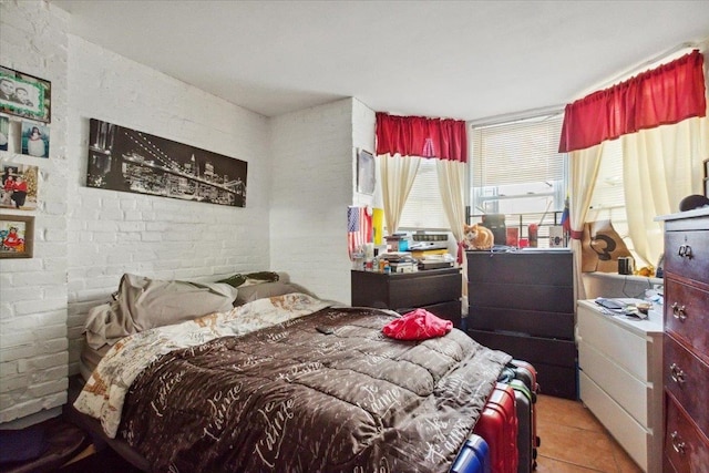 tiled bedroom with brick wall