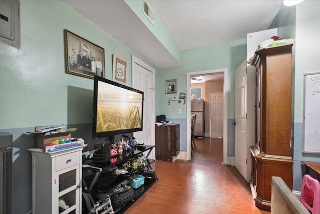 hallway with hardwood / wood-style floors