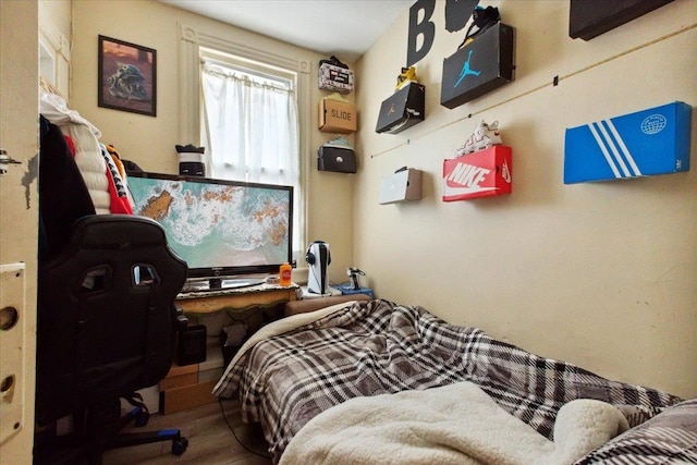 bedroom with hardwood / wood-style flooring