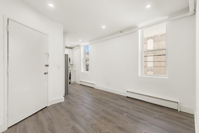 235 Monroe St Unit 10, Hoboken, NJ 07030 - spare room with a baseboard radiator, wood finished floors, and recessed lighting