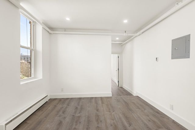 235 Monroe St Unit 10, Hoboken, NJ 07030 - empty room featuring baseboard heating, electric panel, wood finished floors, and recessed lighting