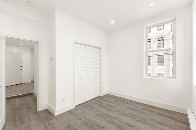 235 Monroe St Unit 10, Hoboken, NJ 07030 - unfurnished bedroom with wood finished floors, recessed lighting, a closet, and baseboard heating