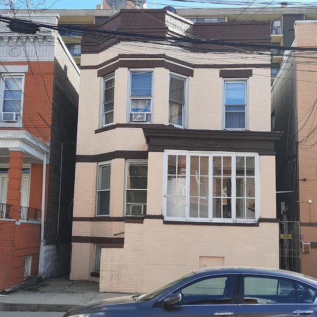 243 46th St, Union City, NJ 07087 - view of front facade featuring cooling unit and brick siding