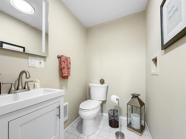 bathroom with vanity, tile patterned floors, and toilet