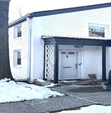 view of snow covered property entrance