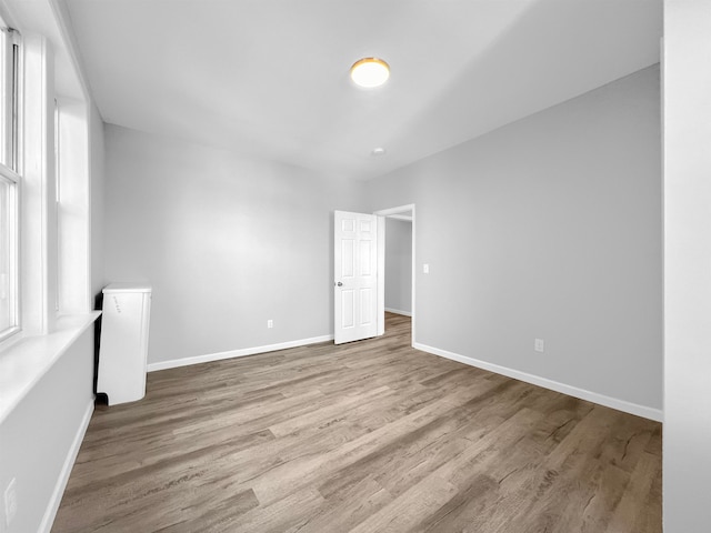 empty room with a healthy amount of sunlight and light wood-type flooring