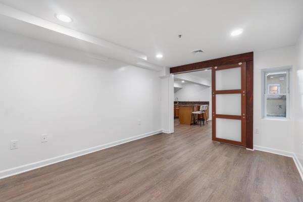 2608 Kennedy Blvd Unit 1, Union City, NJ 07087 - unfurnished living room with recessed lighting, wood finished floors, and bar