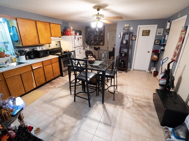 62 Hancock Ave, Jersey City, NJ 07307 - kitchen featuring stainless steel range with gas cooktop, a sink, ceiling fan, and brown cabinetry