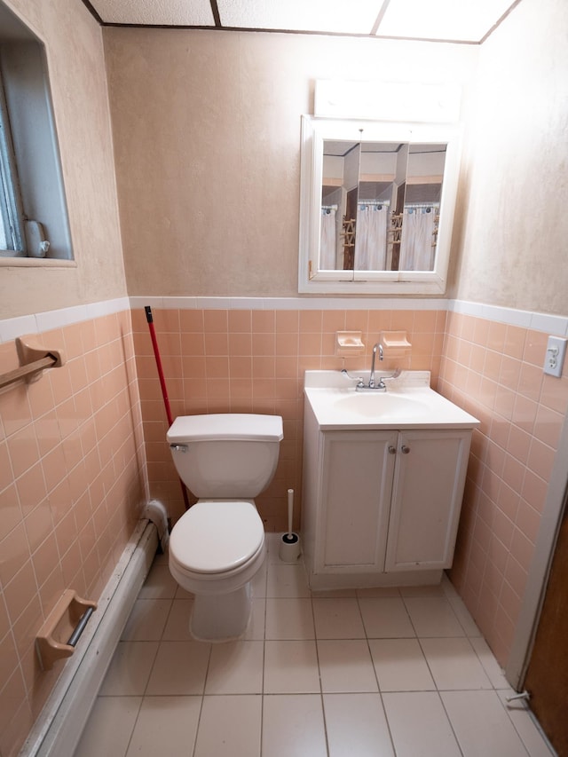 62 Hancock Ave, Jersey City, NJ 07307 - bathroom featuring tile walls, wainscoting, toilet, tile patterned flooring, and vanity