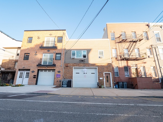 62 Hancock Ave, Jersey City, NJ 07307 - view of front of property with driveway, brick siding, and a garage