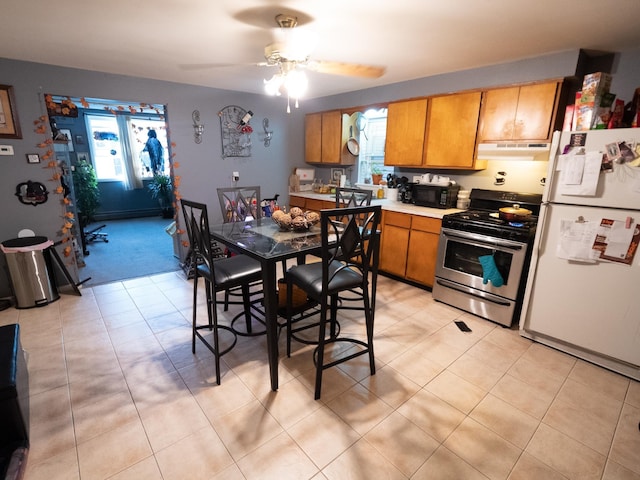 62 Hancock Ave, Jersey City, NJ 07307 - kitchen featuring electric stove, freestanding refrigerator, black microwave, under cabinet range hood, and brown cabinetry