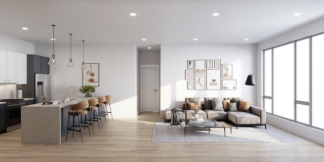 living room with light wood-type flooring and sink