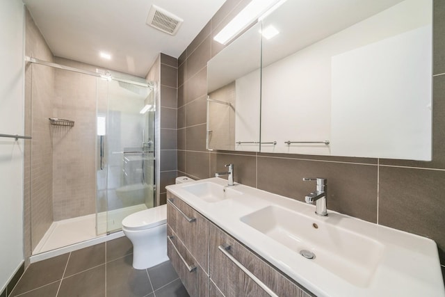 202 Merseles St Unit 503, Jersey City, NJ 07302 - bathroom featuring double vanity, a stall shower, tile patterned flooring, and tile walls