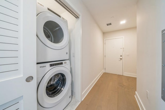 202 Merseles St Unit 503, Jersey City, NJ 07302 - laundry area featuring stacked washer and clothes dryer and light wood finished floors