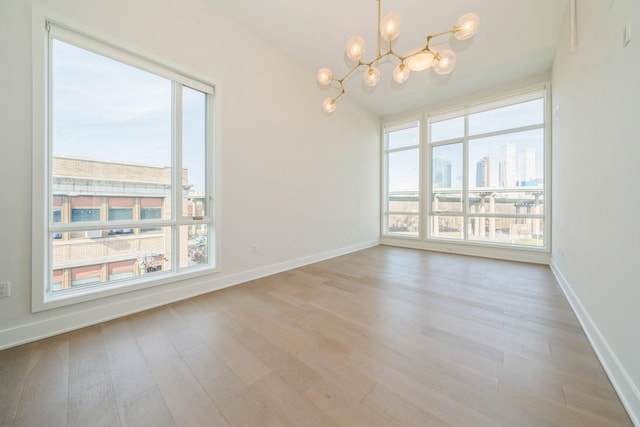 202 Merseles St Unit 503, Jersey City, NJ 07302 - unfurnished room featuring a chandelier, wood finished floors, and a city view