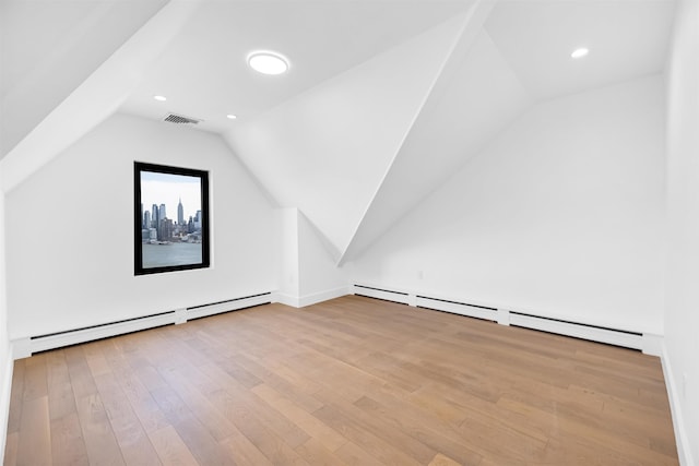829 Boulevard, Weehawken, NJ 07086 - additional living space with a baseboard heating unit, visible vents, lofted ceiling, and light wood-style flooring