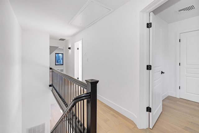 829 Boulevard, Weehawken, NJ 07086 - corridor featuring attic access, visible vents, baseboards, light wood-style flooring, and an upstairs landing