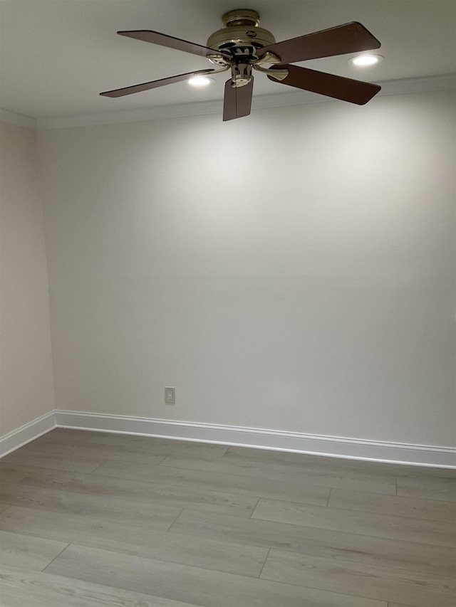 spare room with ceiling fan, light wood-type flooring, and ornamental molding