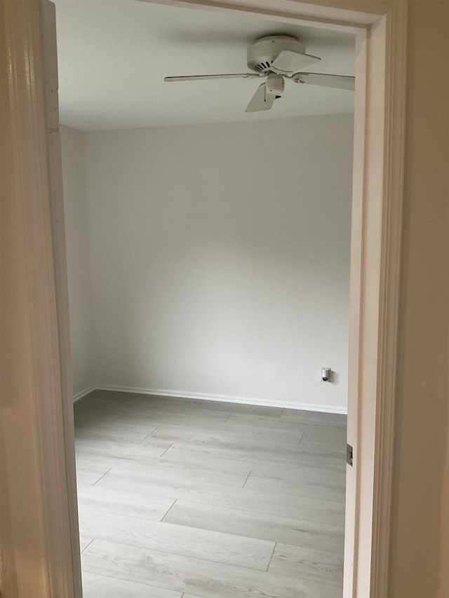 spare room featuring light hardwood / wood-style floors and ceiling fan