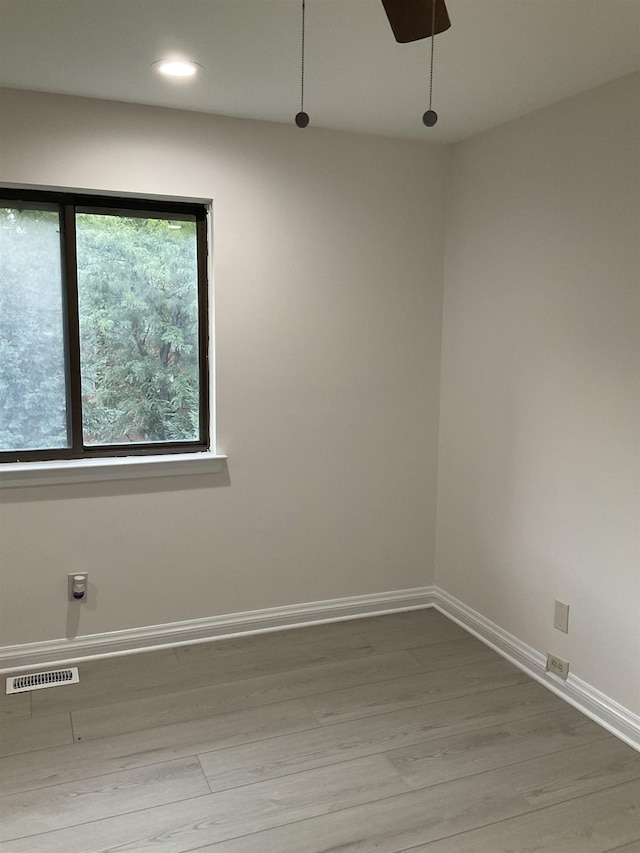 spare room featuring hardwood / wood-style floors and ceiling fan