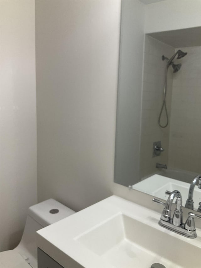 full bathroom with washtub / shower combination, vanity, and toilet