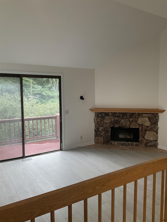 unfurnished living room with a fireplace and a wealth of natural light