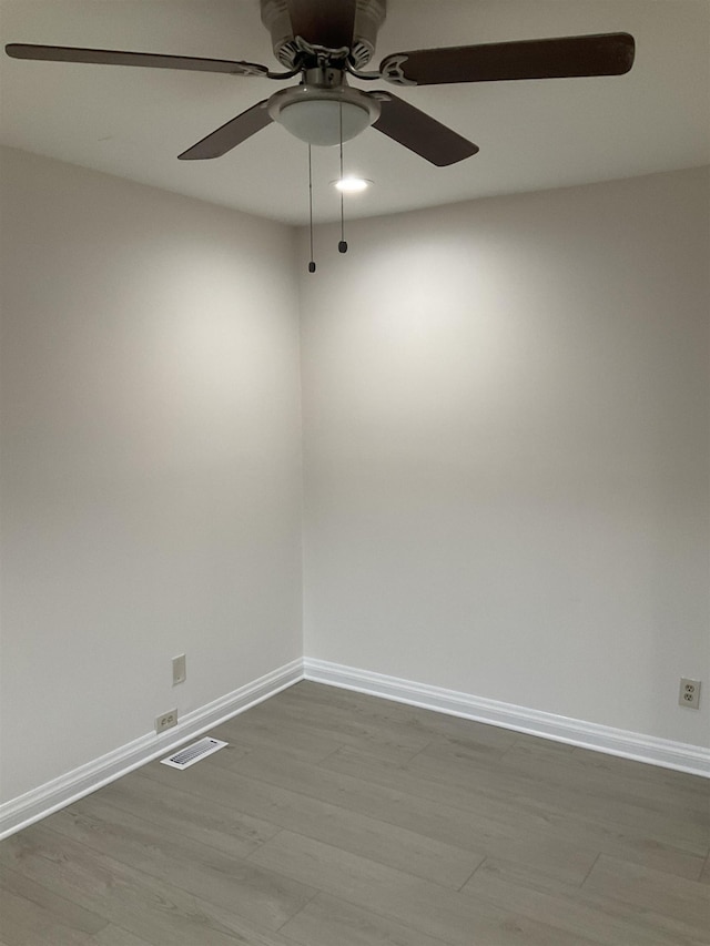 spare room featuring hardwood / wood-style floors and ceiling fan