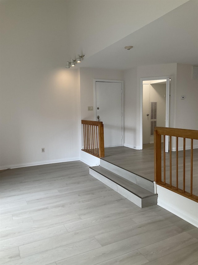 stairs with hardwood / wood-style flooring