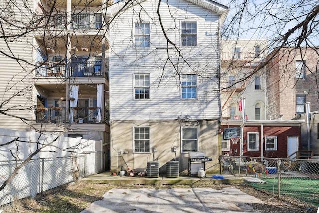 back of house with a fenced backyard