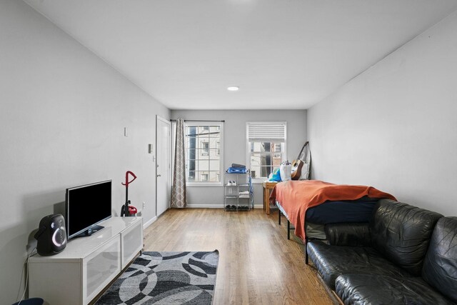 interior space featuring light wood-type flooring and baseboards