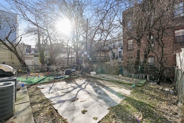 exterior space with a residential view, fence, and central air condition unit