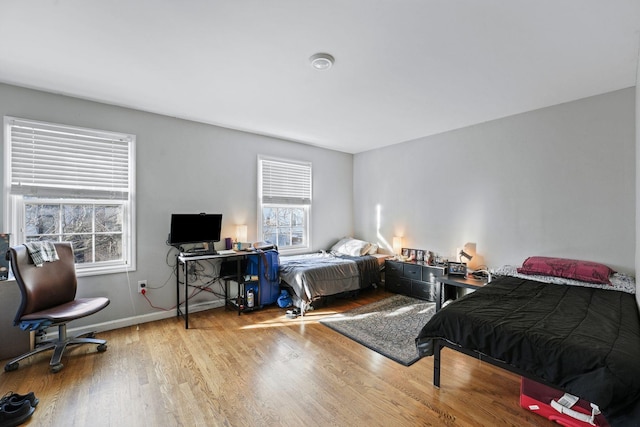 bedroom featuring light wood-style flooring and baseboards