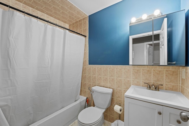 full bath with toilet, shower / tub combo with curtain, tile walls, and vanity